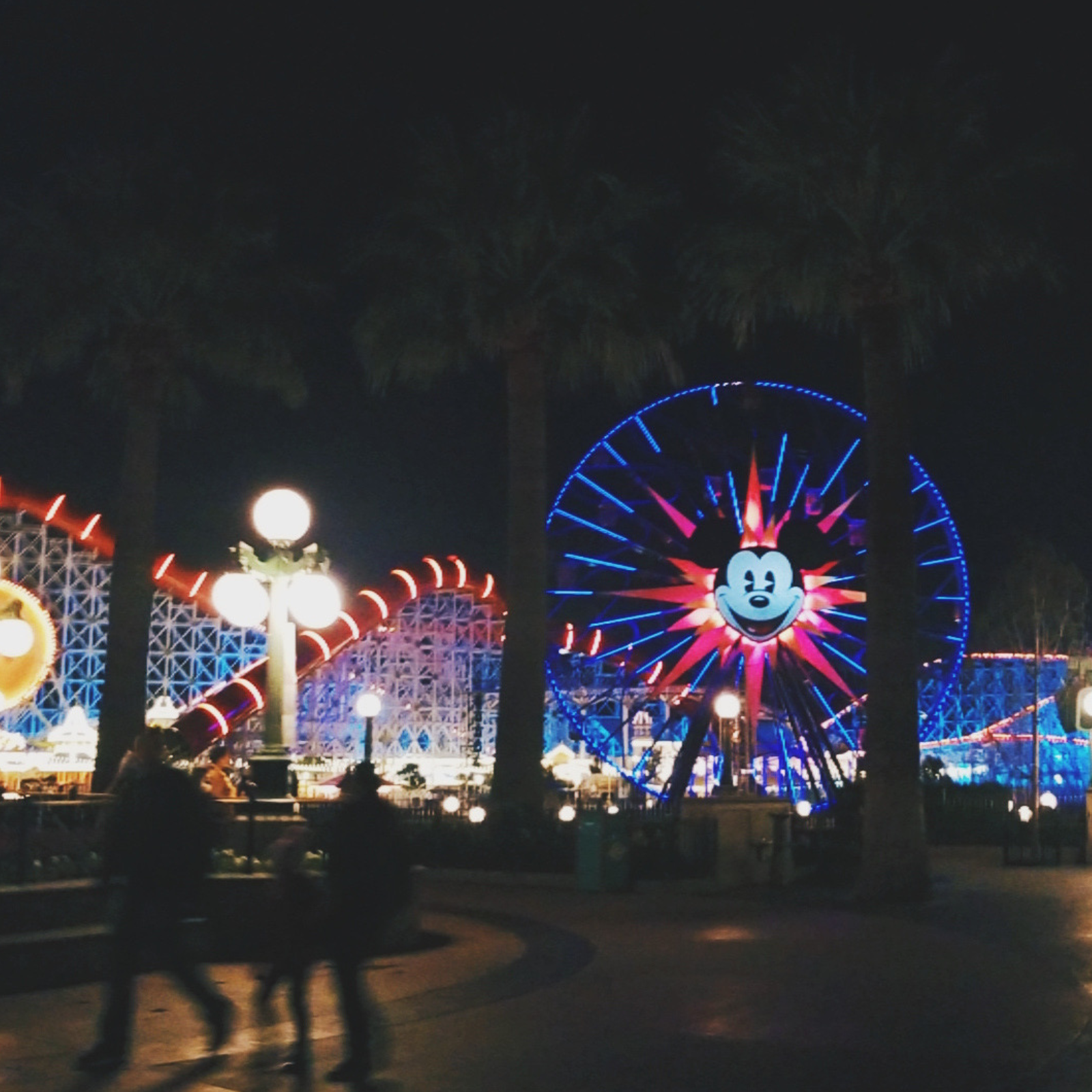 California Adventure at night with the ferris wheel with Mickey Mouse on it, lit up