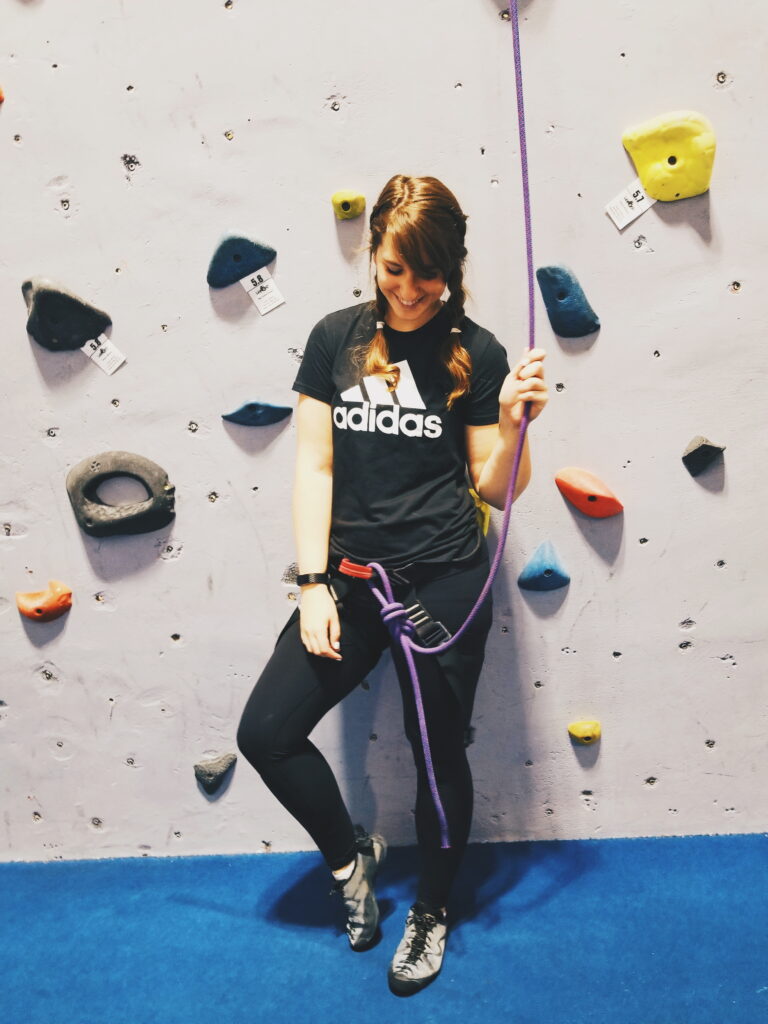 girl in front of rock climbing wall