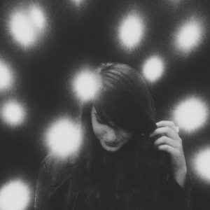 Girl with bright lights behind her, black and white photo